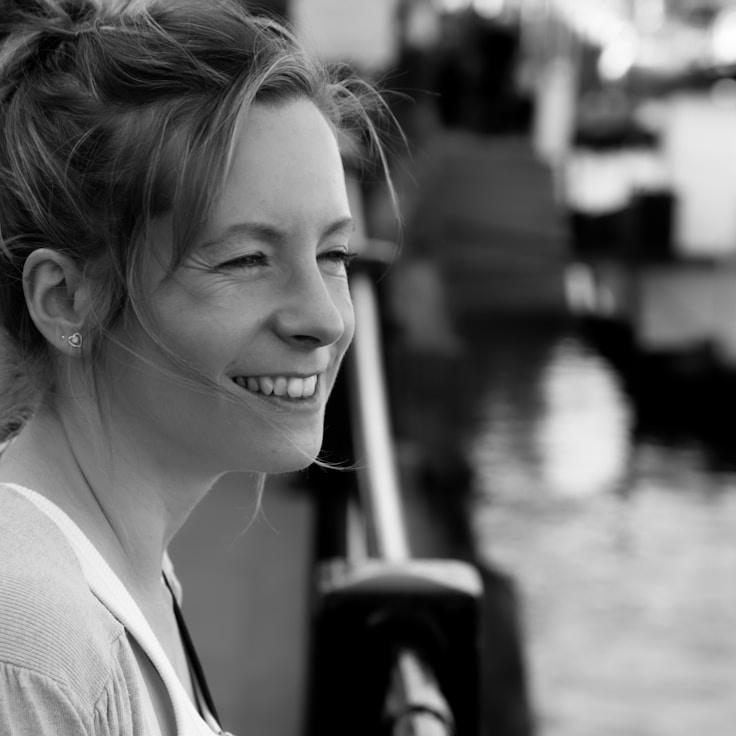 Mira Shah, Lead Design Curator at Wander Language Bonfire, reviewing corporate floral arrangements